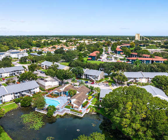 A bird's eye view of a resort with a swimming pool and buildings.