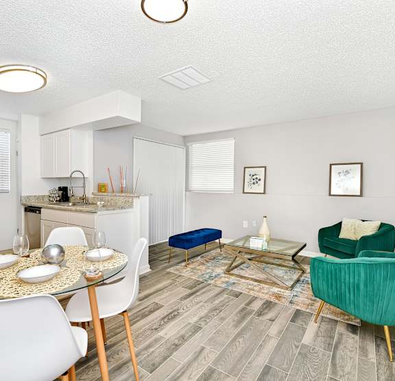 a living room with a ceiling fan and a dining room table with chairs