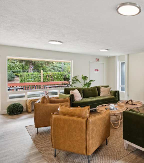 A living room with a fireplace and green couches.