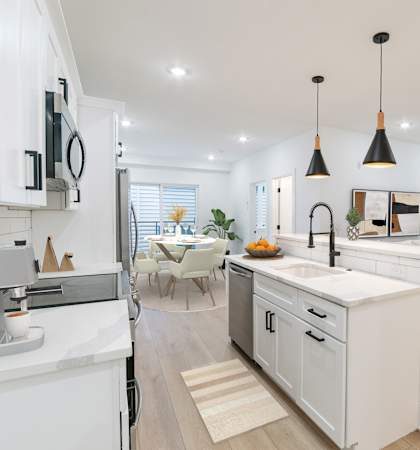 A modern kitchen with white cabinets and a large island.