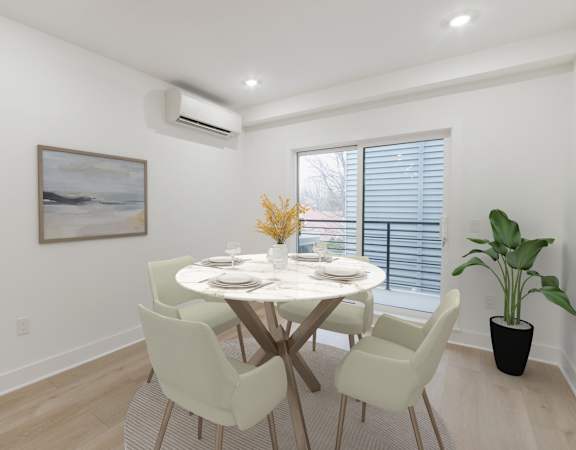 A dining room with a white table and chairs.
