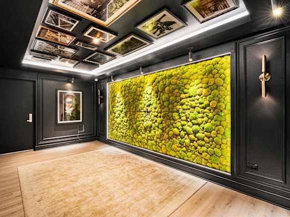 A room with a green wallpaper and a wooden floor at Chateau on Wells, Chicago, Illinois