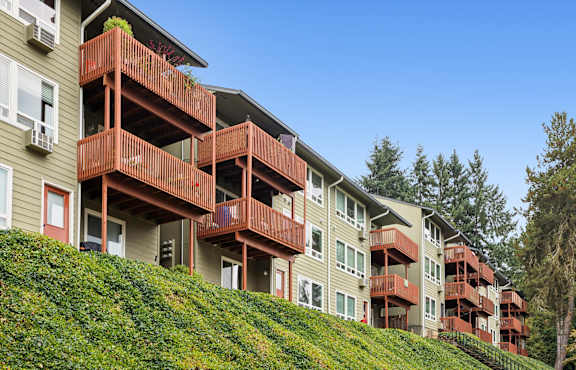 Apartment building with green grass in front.