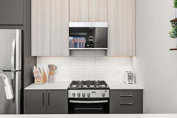 A modern kitchen with a stove, oven, and refrigerator.