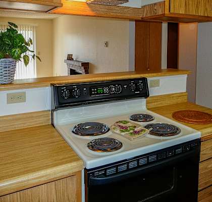 A stove top with four burners and a pot on the right.