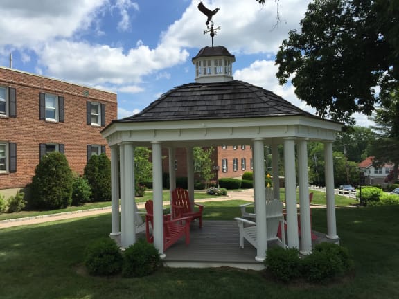 a gazebo in the middle of a lawn