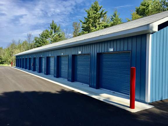 A long blue storage building with number 148 on the side.