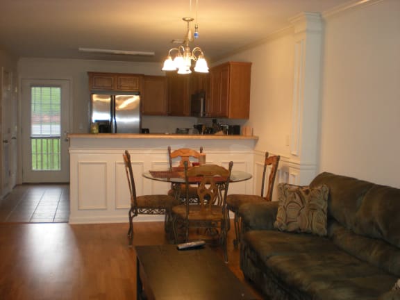 a living room and kitchen with a dining table