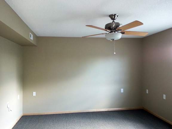 an empty room with a ceiling fan