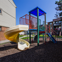 a playground with a slide and a play set