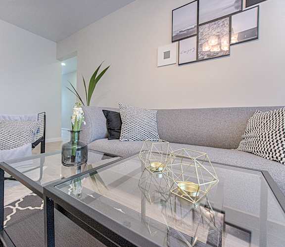 a living room with a glass coffee table