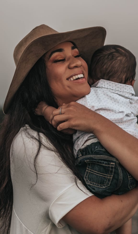 a woman holding a baby in her arms