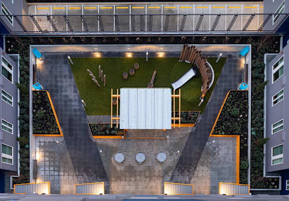 a rendering of an aerial view of a courtyard with a sculpture of a horse and at The Aries at Bitter Lake Apartments, Seattle