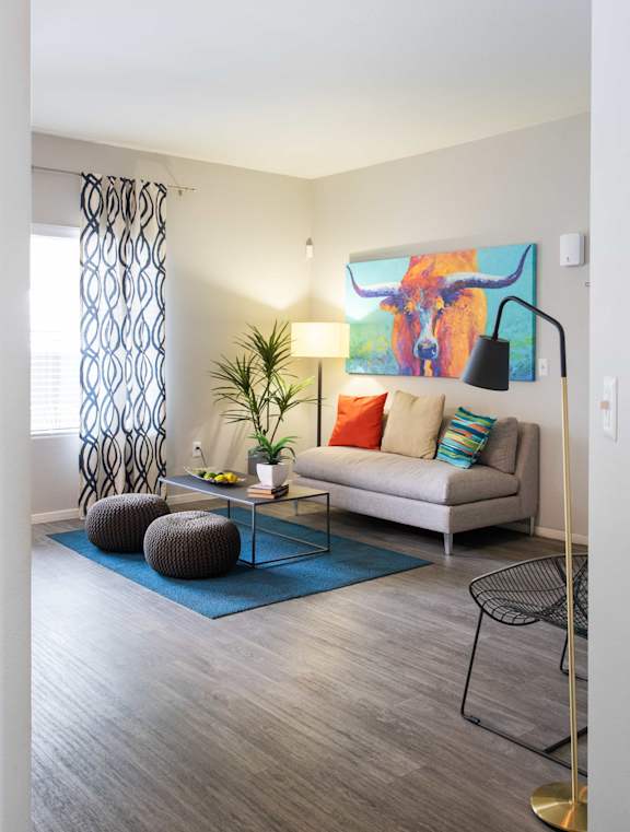 a living room with a couch and a painting of a bull