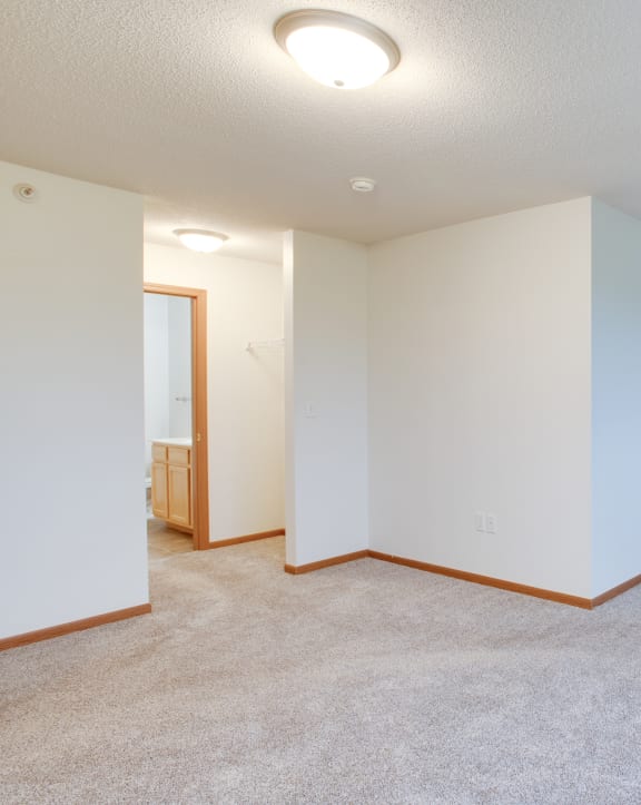 Carpeted Living Room at Pelican Heights Apartments - Detroit Lakes, Minnesota, 56501