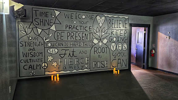 A wall with inspirational quotes written on it.