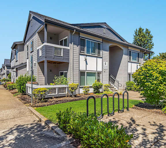 Outside view of a gray apartment building at The Landing Apartments and Townhomes in Oregon City