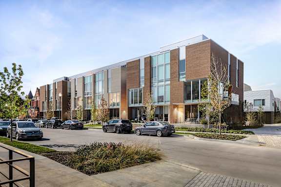 a large brick building with cars parked in front of it