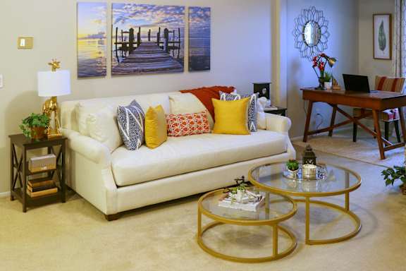 a living room with a white couch and a table at Village Club on Franklin, Southfield, MI 48034