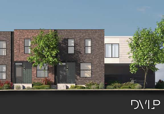 A row of modern brick houses with black front doors.
