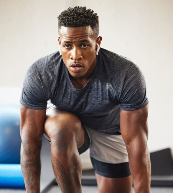 a man doing pushups on the floor in a gym