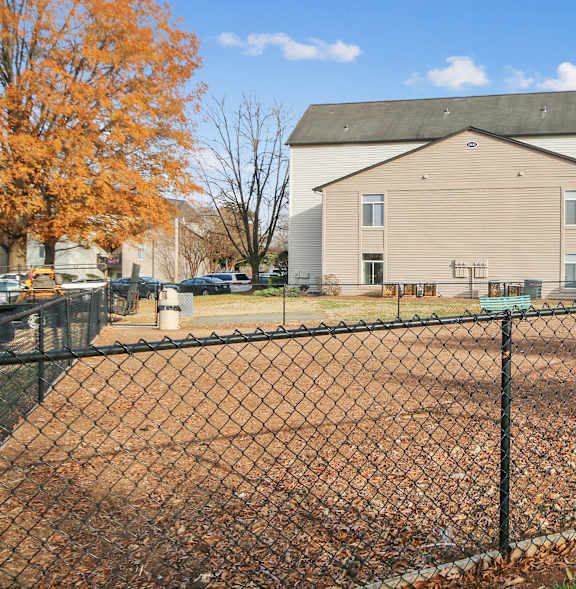 A baseball field is surrounded by a chain link fence.