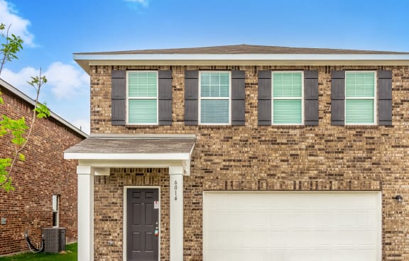 a brick house with a white garage door
