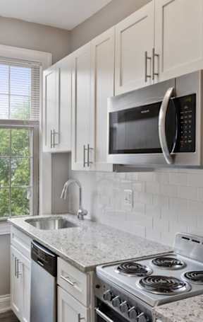 Renovated kitchen with granite countertops and stainless steel appliances