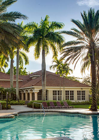 Pool with lounge chairs at Banyan Pointe, Coconut Creek