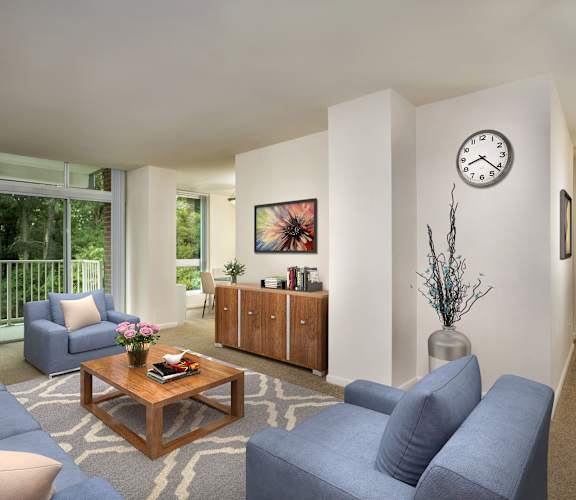 A living room with a sofa, armchair, and coffee table. at Charlestowne North Apartments, Maryland