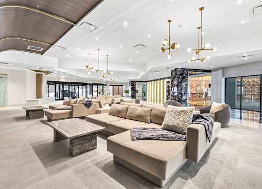 a lobby of a building with couches and tables at Up House, Farmington, 06032