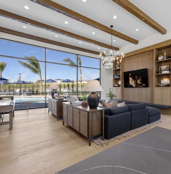 a large living room with a blue couch and a tv  at Westbury Apartments, Rancho Cucamonga, 91739