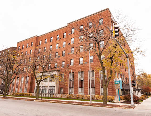 a large red brick building on the corner of a street