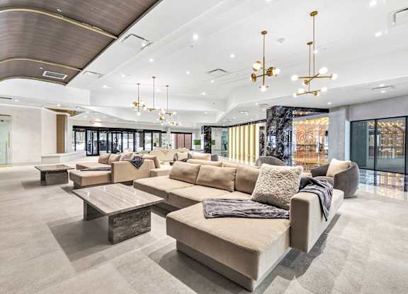 a lobby of a building with couches and tables at Up House, Farmington, 06032