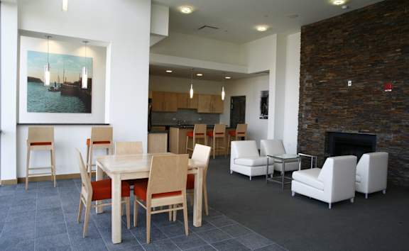 A dining room with a table and chairs.