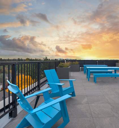 a view of a sunset from a balcony at Arabella Apartment Homes in Shoreline, WA