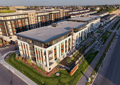 A modern building with a green lawn in front.