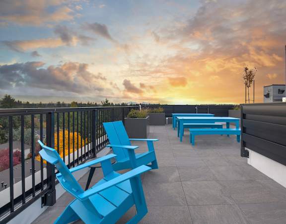 a view of a sunset from a balcony at Arabella Apartment Homes in Shoreline, WA