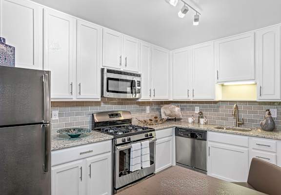 Modern Kitchen With Stainless Steel Appliances And Double Door Refrigerators at Versailles Apartments, Towson, 21204