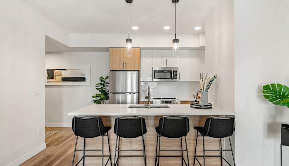 a large kitchen with a table and chairs