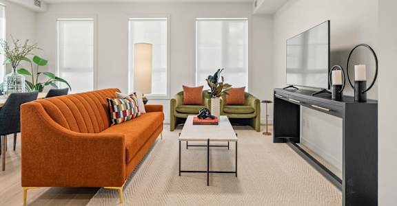A living room with a television, couches, and a coffee table.