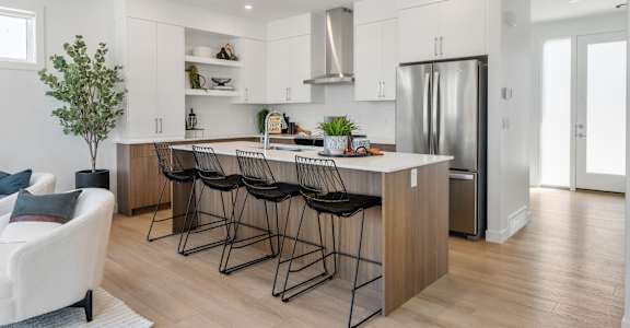 A modern kitchen with a white and wood color scheme.