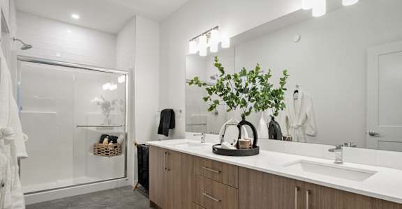 A bathroom with a white sink and a mirror.