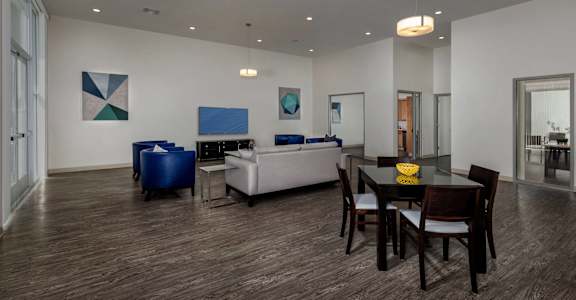 a living room and dining room with a table and chairs