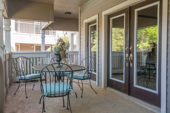 A patio with a table and chairs.