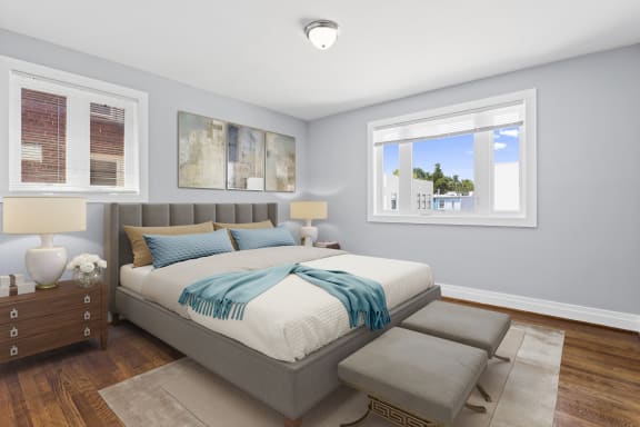 a bedroom with a bed and two windows