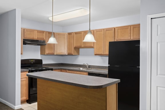 a kitchen with wooden cabinets and black appliances
