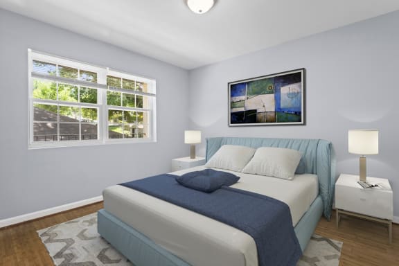 a bedroom with a bed and two windows