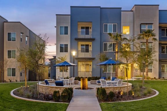 a courtyard with tables and chairs in front of an apartment buildingat Westbury Apartments, Rancho Cucamonga, 91739