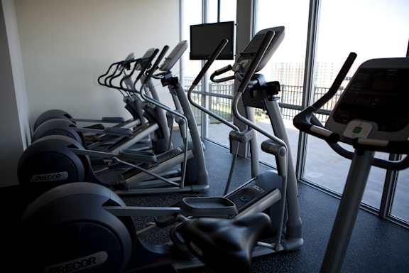 A row of treadmills in a gym.at 66 Main, New York